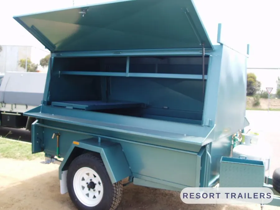 Teal BBQ trailer with the servery hatch raised — built by Resort Trailers