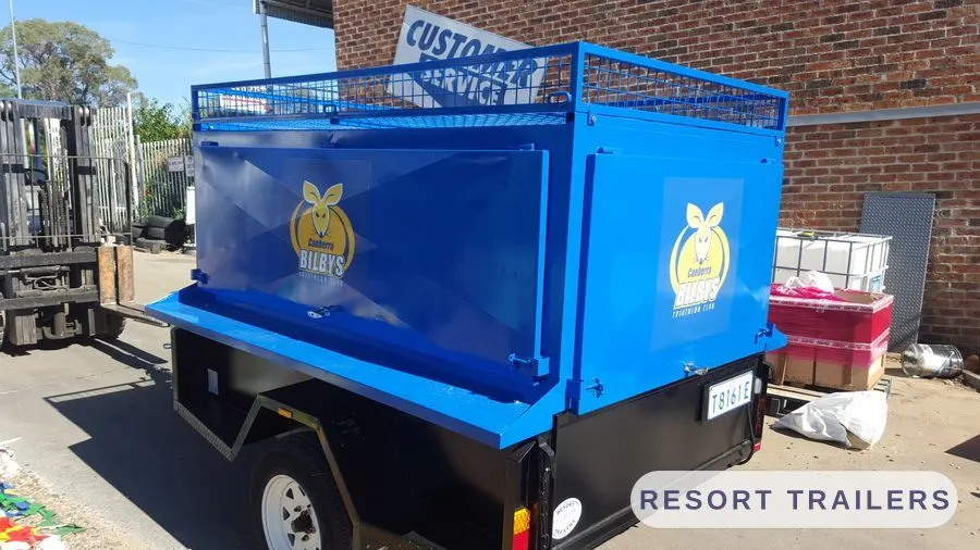 Blue caged trailer with mesh sides and branded panels — built by Resort Trailers