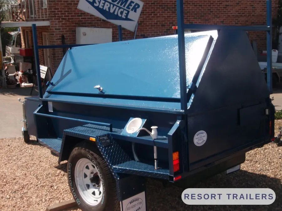 Canopy trailer with roof rack frame over the lid — built by Resort Trailers