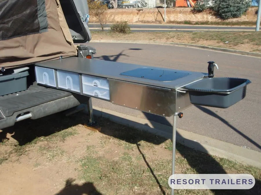 Stainless camp kitchen bench extended from the trailer — built by Resort Trailers