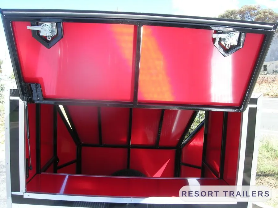 Canopy raised on the car transporter, showing the lined interior — built by Resort Trailers