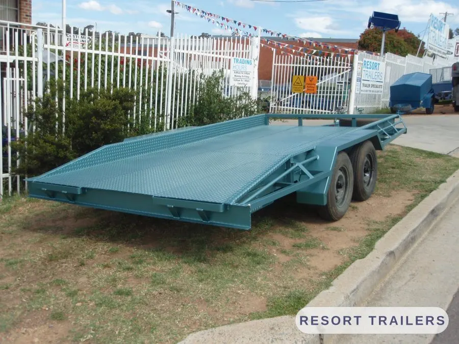 Teal car float with tilting deck and low load angle — built by Resort Trailers