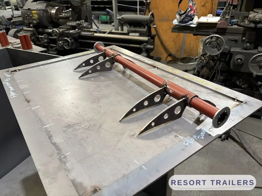 Burner manifold and mounting fins laid out on the bench