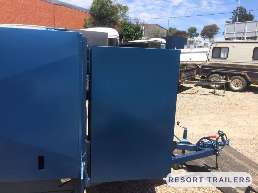 Mowing trailer with the side gate swung open — built by Resort Trailers