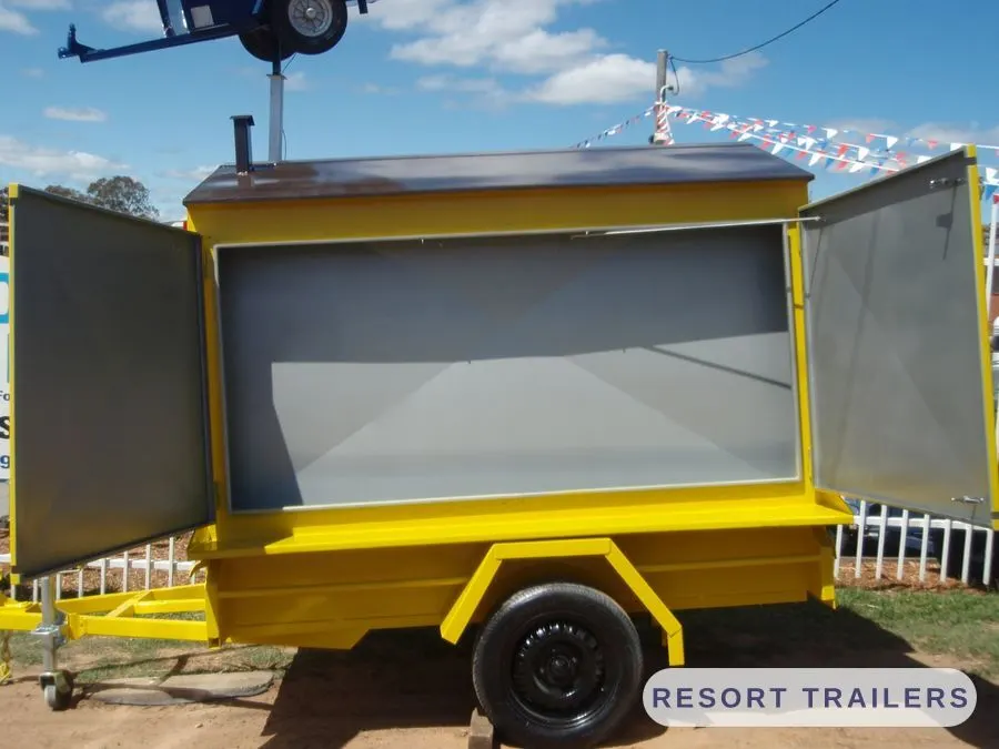 Yellow display trailer with fold-out side panels — built by Resort Trailers