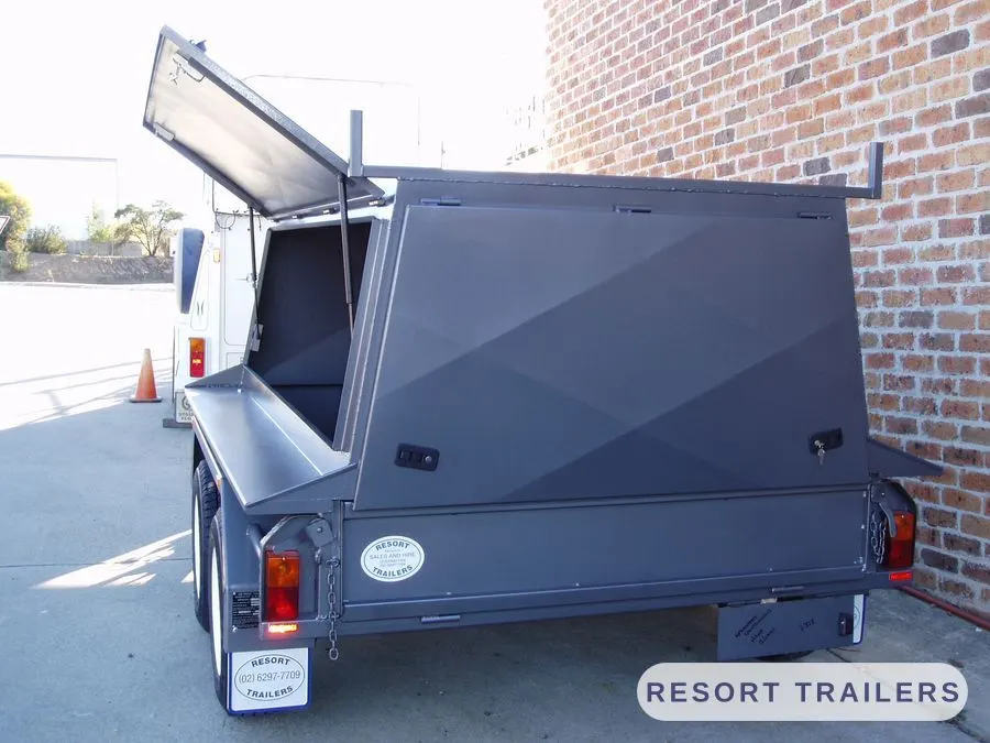 Grey canopy trailer with the lid raised on gas struts — built by Resort Trailers