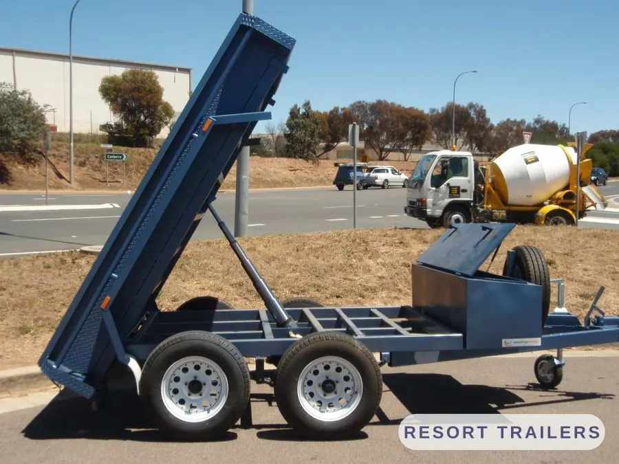 Dual-axle tipping trailer tipping its load on site — built by Resort Trailers