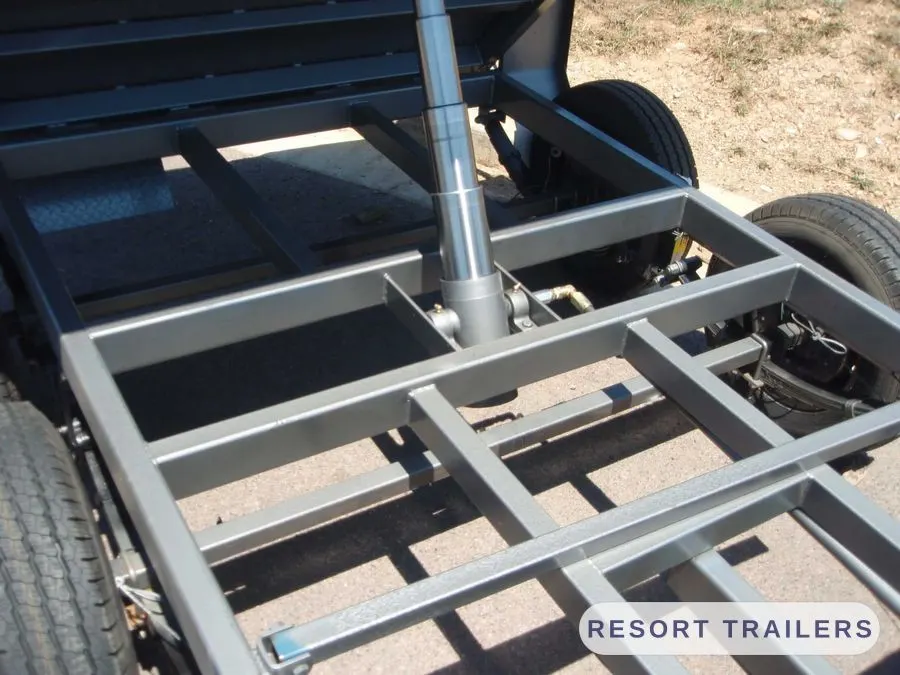 Underside of a dual-axle tipping trailer showing the hoist — built by Resort Trailers