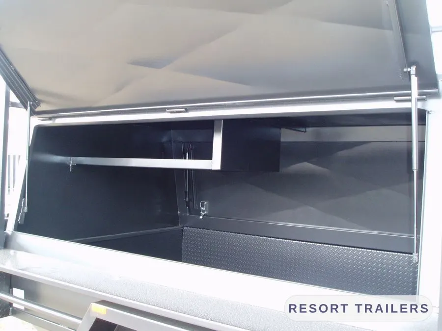 Inside the canopy, showing shelving and lining — built by Resort Trailers